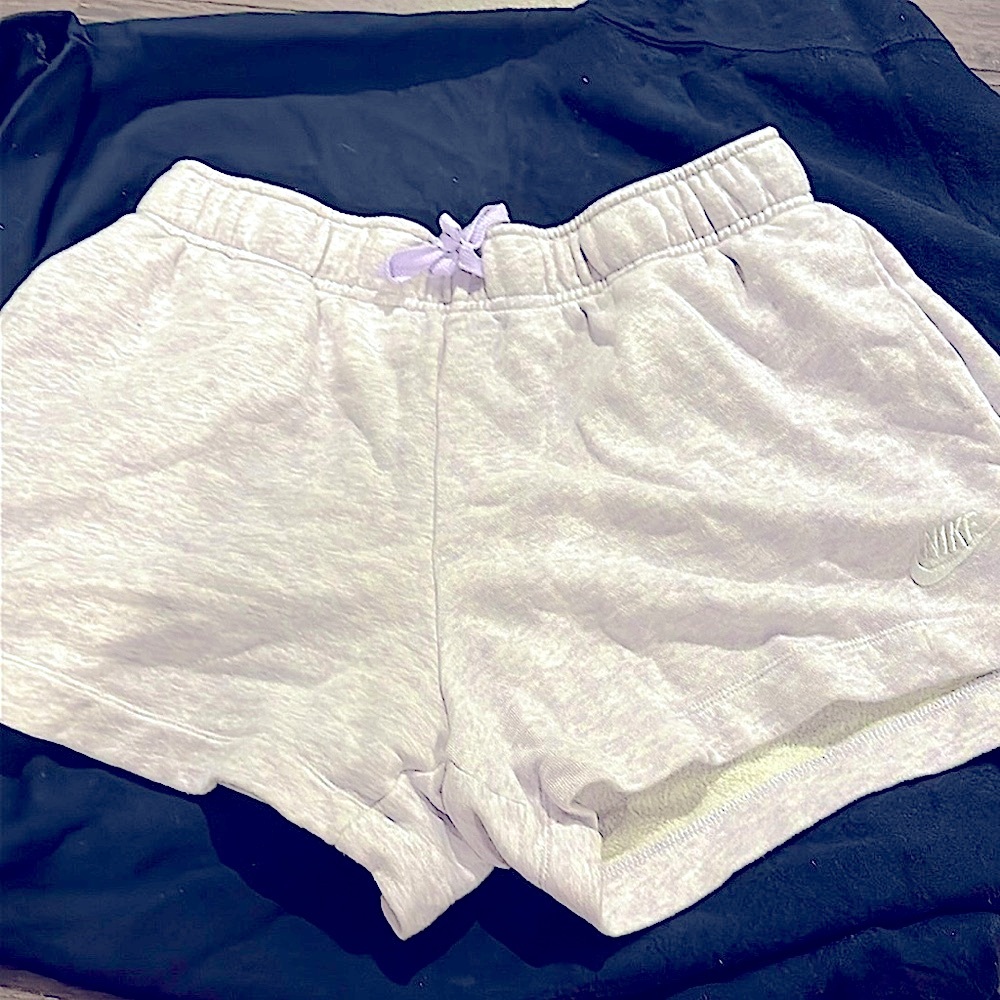 Very light purple Nike shorts. Medium